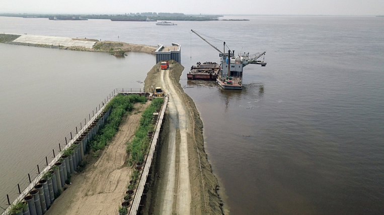 Khabarovsk completed a temporary dam, served a mass on top of a dyke and asked China not to pour more water
